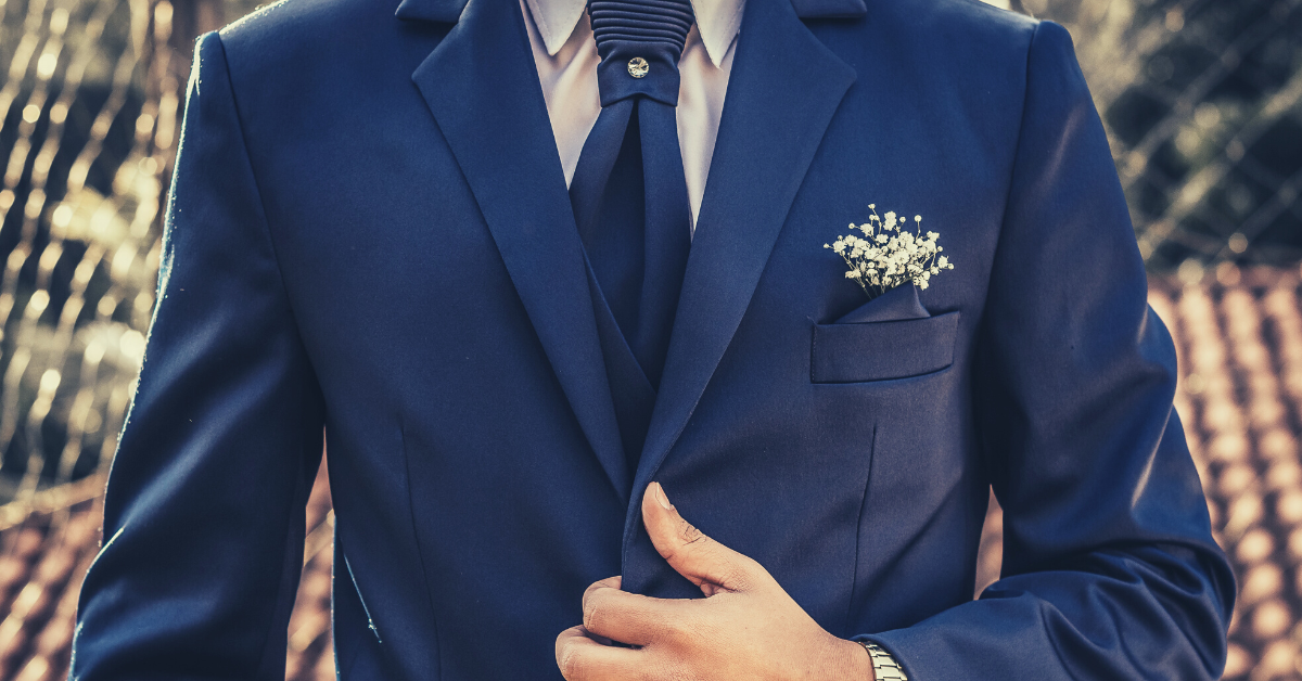 close up image of a man in a sharp blue suit