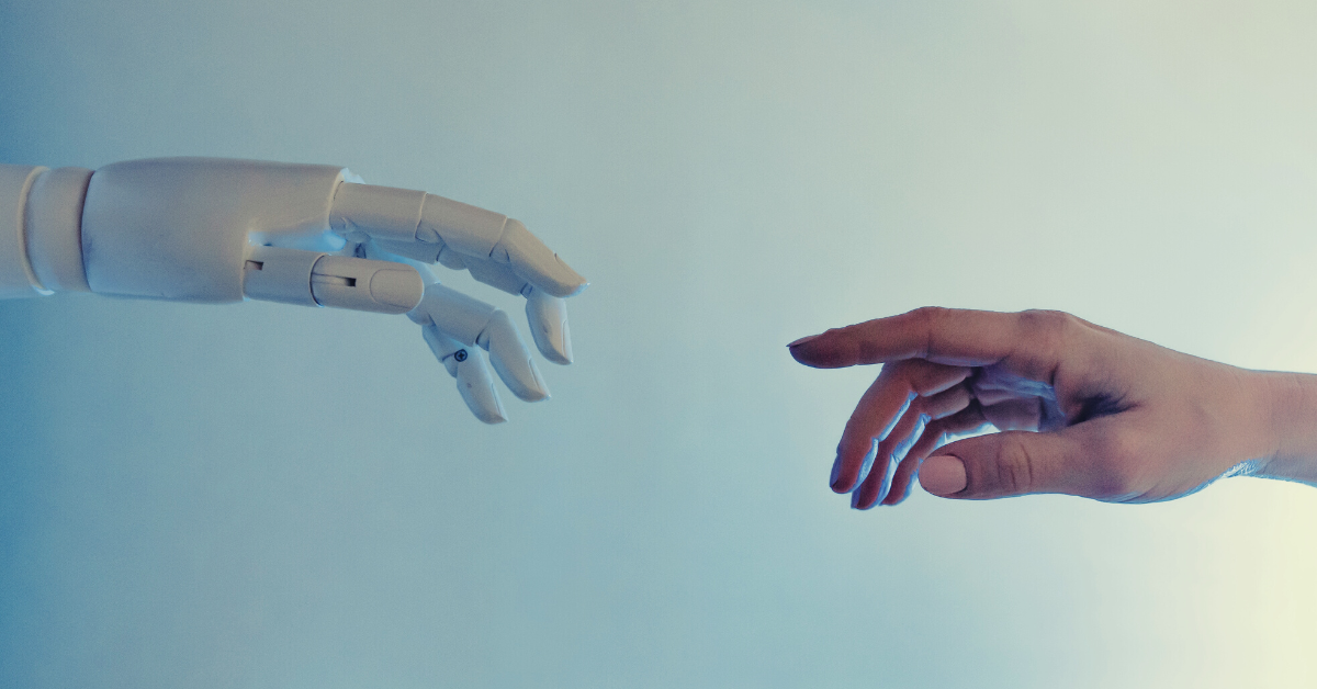 image of two hands reaching out to each other, one hand is human and the other is a robot