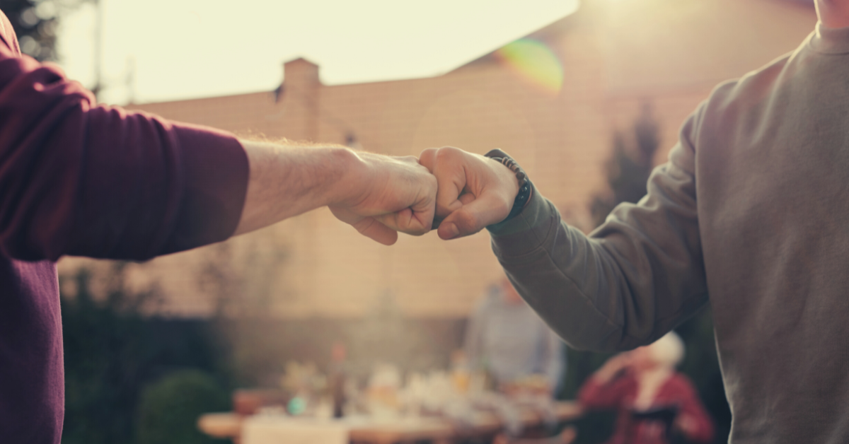 image of two people giving each other a fist bump